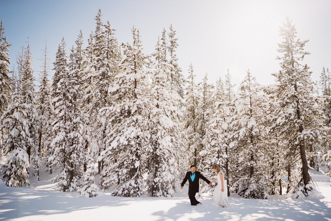 Bride and Groom walking through the snow